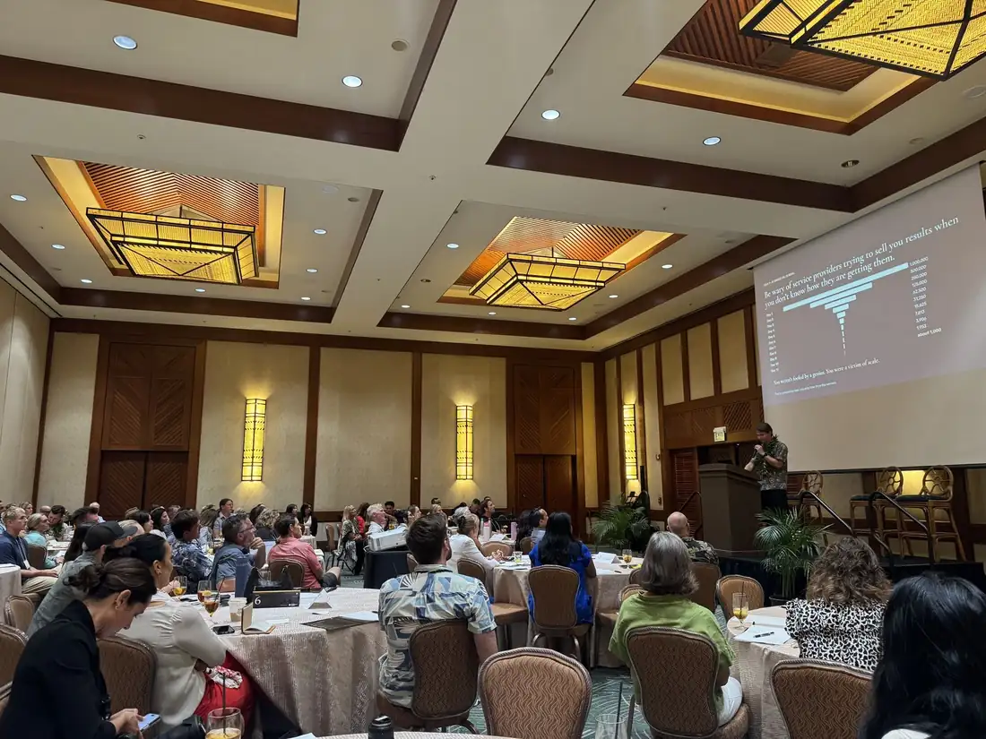 Mark Mathany presenting data to a full conference room